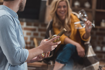 couple with bottle of wine and glasses