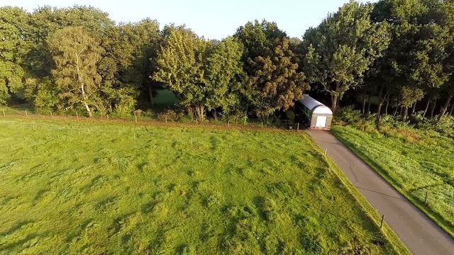 Truck drives in to a forest over a small road