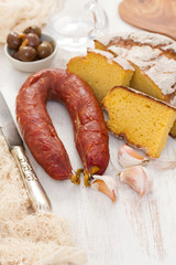 smoked sausage chorizo with corn bread on wooden background