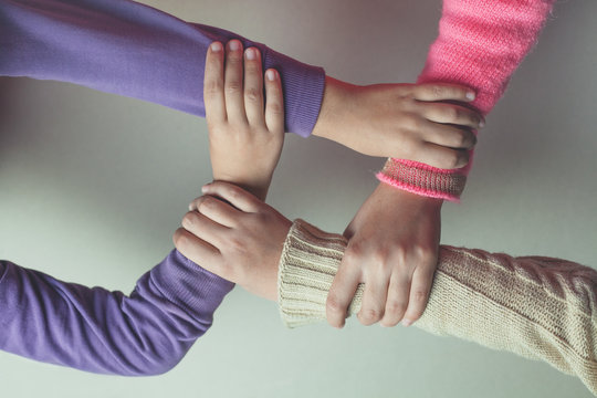 Kids Hands Join Together On The Table.