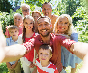 happy family taking selfie in summer garden - Powered by Adobe