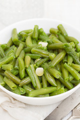 boiled green beans with garlic in white bowl