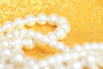 Pile of pearls on golden christmas background