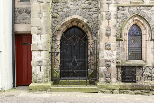 Caernarfon harbour Masonic lodge gate with the number 321 and freemasonry symbols in the wrought iron work which relate to their heritage from the middle ages. 