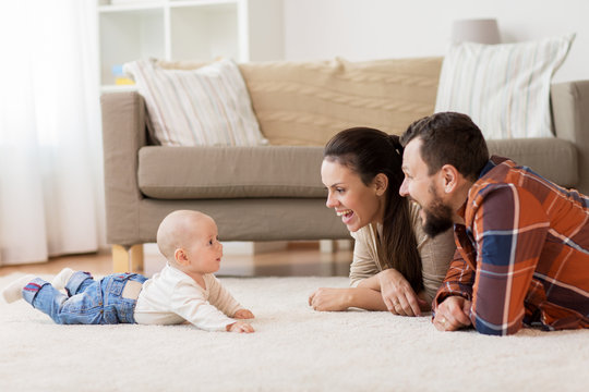 happy family playing with baby at home