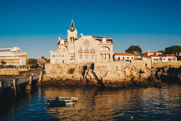 Sea view of Cascais city in Portugal at sunrise with fishing boats visible. Cascais, Lisbon...