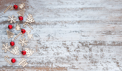 Christmas pattern. Background with wooden Christmas toys and red Christmas balls.  New Year's symbols. Flat lay, top view.