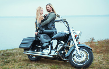Plakat Couple on a bike in a leather jackets 