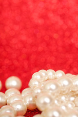 Pile of pearls on red christmas background