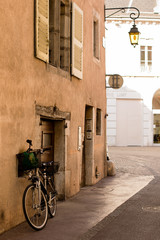Bicycle at the door of a house in a scenic spot in the town of  Annecy, France