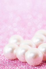 Pile of pearls on pink festive background
