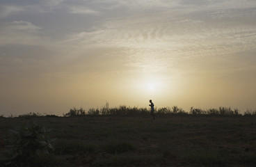 Obraz na płótnie Canvas Running man silhouette on sunset background