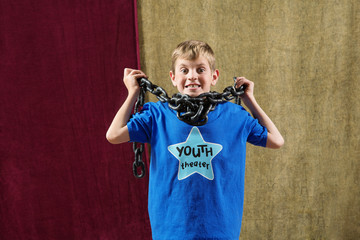 Young actor with chain around neck