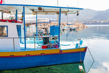 Fototapeta na wymiar Fishing boats in Pomos harbour and crystal clear waters