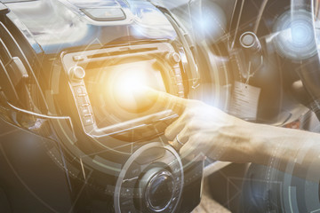 Transportation,technology and vehicle concept - man using car system control pushing panel button...