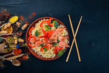 Asian food with seafood and vegetables. Shrimp, broccoli, paprika, spices. Top view. Free space for text.