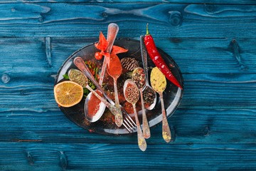 Spices and herbs. A large assortment of spices. Indian cuisine. On the wooden table. Top view. Free space for text.