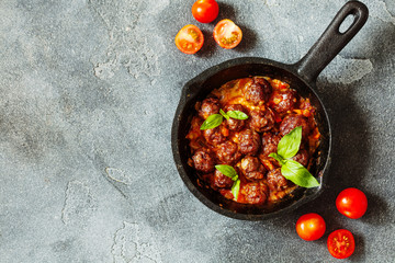 Swedish meatballs with tomato sauce in frying pan top view