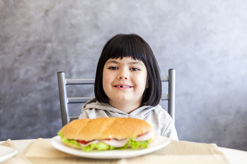 Portrait of little girl having breakfast at home