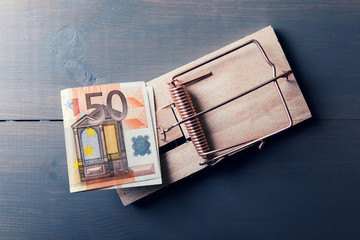 risky money - euro bill in mouse trap