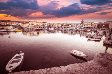 RETHYMNO, CRETE ISLAND, GREECE – JUNE 29, 2016: View of the old venetian port of Rethimno at sunset.
