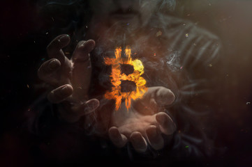 Burning symbol of bitcoin with man in the background. Conception of risk management in money...