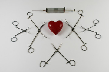 Medical surgical Instruments and heart on white background.