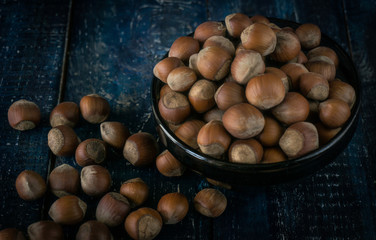 Group of hazelnuts on wooden rustic background