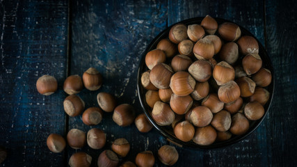 Group of hazelnuts on wooden rustic background