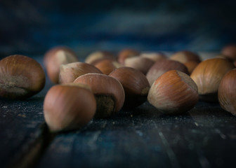 Group of hazelnuts on wooden rustic background