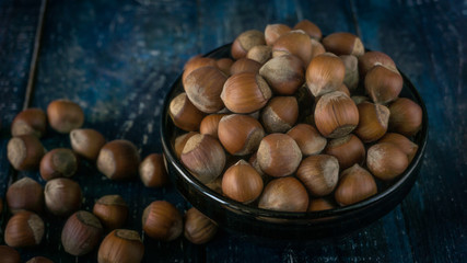 Group of hazelnuts on wooden rustic background