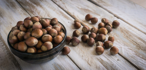 Group of hazelnuts on wooden rustic background