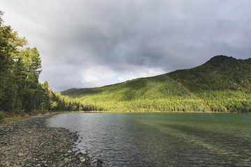 Rainbow. Lower Multinskoe lake, Altai mountains. Russia. Autumn landscape