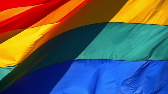 Slow motion gay pride flag blowing in the wind.