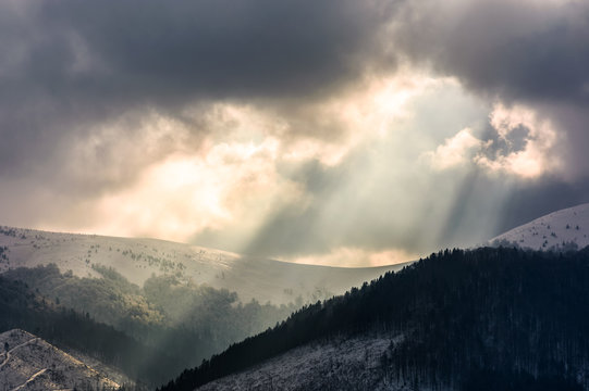 beams of light over the mountains. gorgeous scenery on a cloudy day in winter
