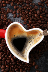 Red Heart Coffee cup and beans on table