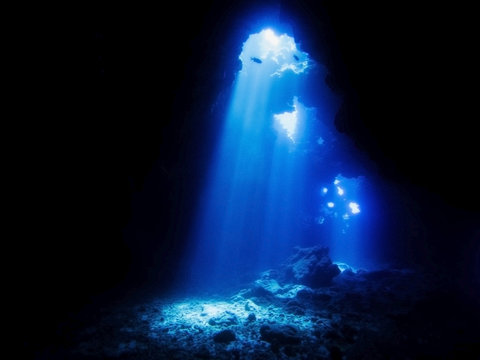 Cathedrals Dive Site Hawaii with Beams of Sunlight Entering Lava Cave