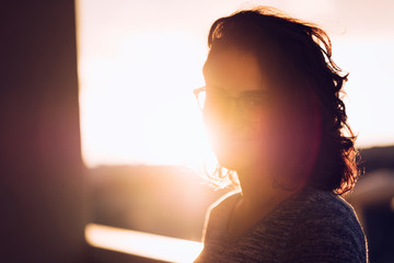 Young woman portrait with sun behind