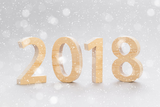 Postcard template 2018 Happy New Year. numbers cut from a tree on a gray background. Snowflakes in the background