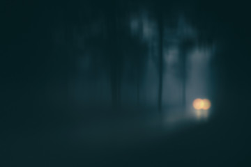 car in country road with fog and low visibility. Blur added