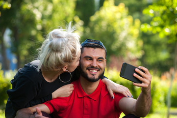 Happy couple making selfie using smartphone