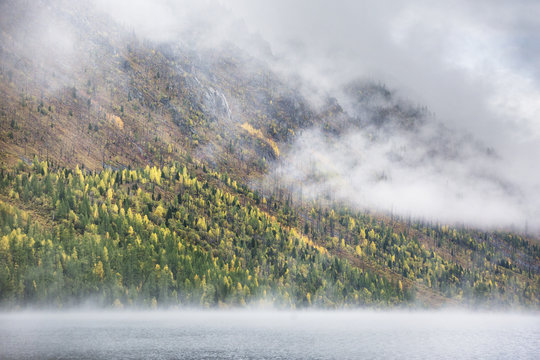 Foggy morning. Lower Multinskoe Lake. Mountain Altai autumn landscape