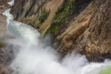 Lower falls Yellowstone river. Raging waters. Spray from waterfall.