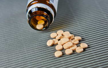 Pill bottle with spilling medicine tablets