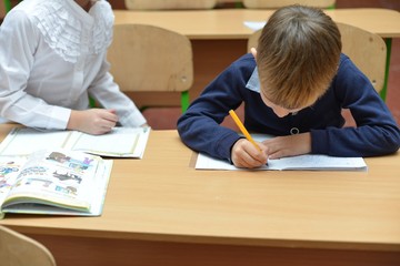 education, children, technology, science and people concept - group of happy kids building robots...