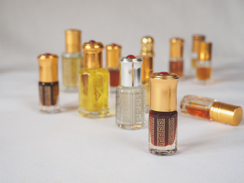 Close up shot of arabian oud oil made of agar wood in a beautiful glass jar. 
