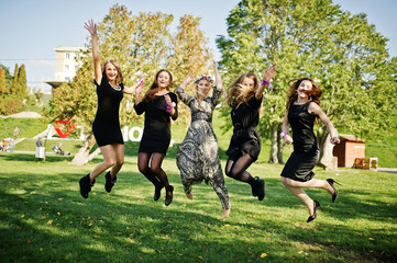 Five girls wear on black jumping at hen party.