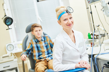 smiling female doctor or ENT ear nose throat with boy patient in clinic