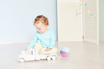 child plays with a car in the studio