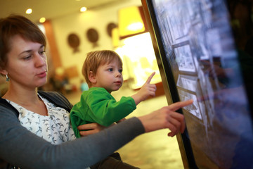Mother with son using touch screen
